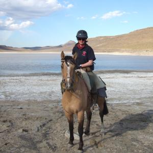 Sophie Neville at a salt lake in Argentia whilst riding across South America to raise funds to combat HIVAIDS