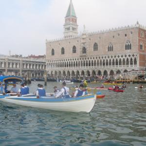 Sophie Neville filming aboard The Drapers Schallop at St Marks Square in Venice Olympic Gold Medalist Ed Coode is rowing stroke
