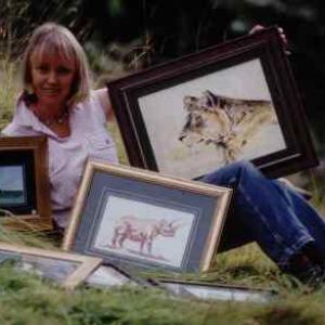 Sophie Neville with a selection of her paintings of birds landscapes and African wildlife