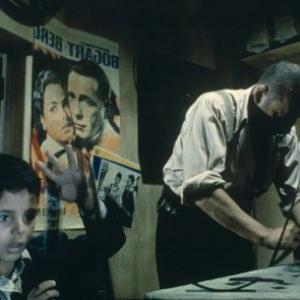 Still of Salvatore Cascio and Philippe Noiret in Nuovo Cinema Paradiso 1988