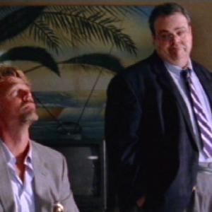 Gerald Owens and John Schneider examine the crime scene in Wild Things Foursome