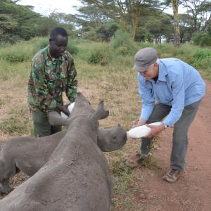Turk Pipkin with orphaned baby rhinos Hope and NIcky at Lew Wildlife Conservancy. Film Shoot for The Nobelity Project