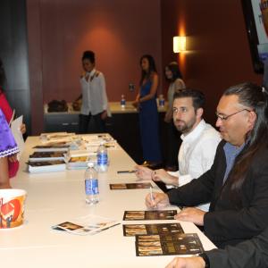 Booboo Stewart Jon Proudstar and Brent Ryan Green autographing posters following the premiere of Running Deer