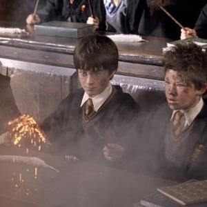 Harry Potter DANIEL RADCLIFFE looks on in shock while Seamus DEVON MURRAY is surprised by the sudden explosion of his wand