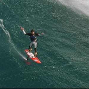 Rush Randle glides above the face of a wave riding the new hydrofoil surfboard at Jaws  the famed big wave spot on Maui