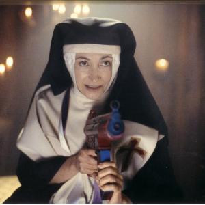 Sister Gloria shooting Holy Water from an Uzi Supersoaker - 