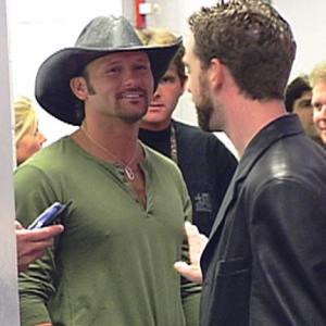 Brent Roske directs singer Tim McGraw backstage at the Staples Center for the NBC music special 'Superstar'. Faith Hill, also in the program, can be seen in the background.