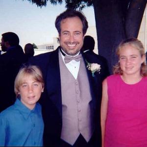 Richard Rossi receiving an award in Hollywood accompanied by his children Joshua and Karis.