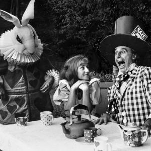 Ricardo Rusch as the White Rabbit with Janet Bowran as Alice and Trevor Hughes as the Mad Hatter in play Alice in Wonderland directed by Buck Richardson