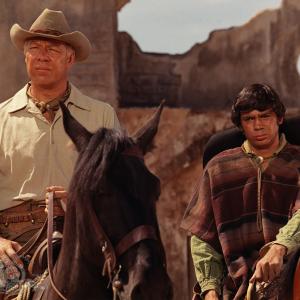 Still of George Kennedy and Reni Santoni in Guns of the Magnificent Seven 1969