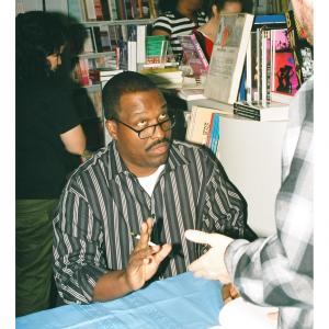 Rodney discusses his best selling book You Can Bank on Your Voice with a fan at a book signing event in Studio City