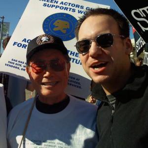 Stephen Scaia picketing with George Takei during the WGA Strike