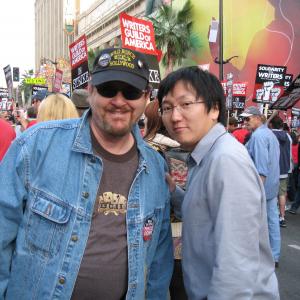 Gregory Schmauss with Masi Oka at the WGA Writers Rally event in Hollywood California