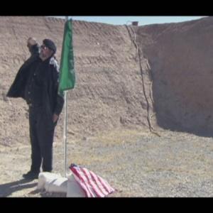 J Neil Schulman as Ali in a scene from Lady Magdalenes in which as an al Qaeda operative he has just thrown the American flag on the ground and hoisted an al Qaeda flag