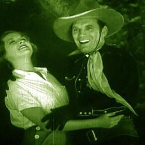 Phoebe Logan and Fred Scott in The Fighting Deputy 1937