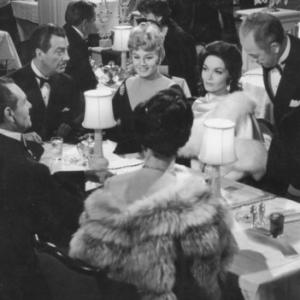 From Left to Right facing camera Robert Taylor Shelly Winters and Lisa Seagram as Madge in the filmA House is Not a Home1964