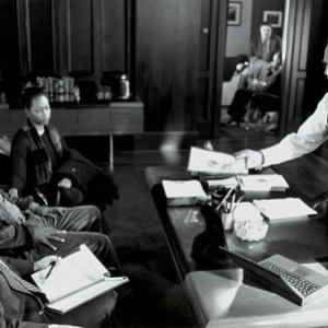 Morewitz (Gene Wolande), Danny (Samuel L. Jackson) and his wife (Regina Taylor), listen to the D.A. (Jack Shearer) spell out the charges in THE NEGOTIATOR.