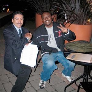 WEST HOLLYWOOD CA  APRIL 28 Directorwriter David Mouton R cast actor Alexander Sibaja giving him the script with a principle role as a limousine driver for his first feature film Vapors as they go over his script at Starbucks Coffe on April 28 2005 in West Hollywood California