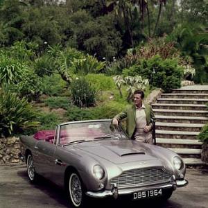 ROBERT STACK AT HOME IN BEVERLY HILLS CA. WITH HIS 1964 ASTIN MARTIN DB5, 1964