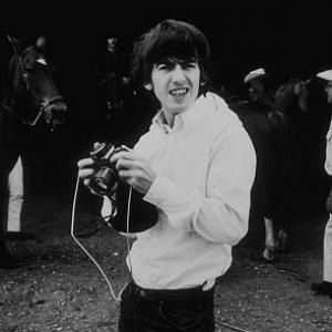 George Harrison with camera Ringo Starr in background in Ozarks Arkansas c 1965
