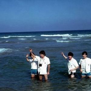 The Beatles  Ringo Starr George Harrison John Lennon Paul McCartney wades in the water