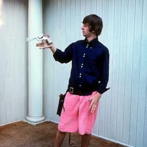 The Beatles Ringo Starr in a pink towel twirls his gun 