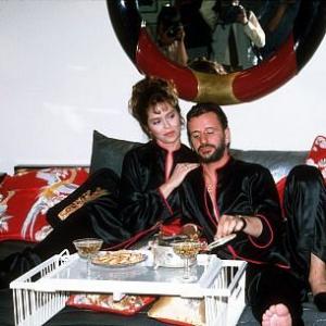 Ringo Starr and wife Barbara Bach in bed with some snacks.