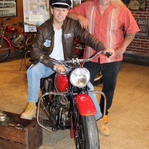 Perry D. Sullivan with Ernie Cuevas during a photo shoot with an old indian motorcycle.