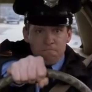 Kevin Theis as Cop O'Malley in 