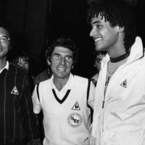 Arthur Ashe and Yannick Noah support Adrian Stonebridge during the 1982 Davis Cup in Grenoble France  showing that Tennis Does Count!