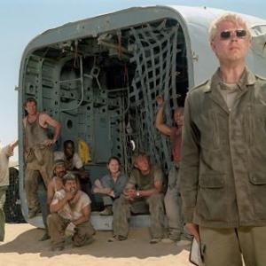 The mysterious and eccentric Elliott (Giovanni Ribisi, foreground) insists that he is the only hope for a group of passengers of a downed plane, including (left to right) Ian (Hugh Laurie), Towns (Dennis Quaid), AJ (Tyrese Gibson), Rady (Kevork Malikyan), Sammi (Jacob Vargas), Kelly (Miranda Otto), Liddle (Scott Michael Campbell) and Jeremy (Kirk Jones).