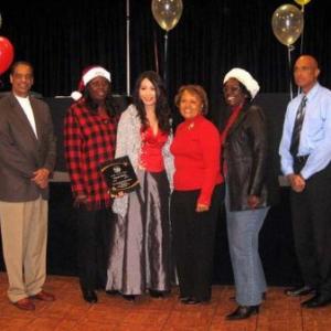 Los Angeles, CA -- Linda Wang (center) the recipient of the yearly Goodwill Award at the 56th Annual Compton Christmas parade dinner event with Compton City's officials.