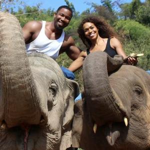 Couple Michael Jai White and Gillian Iliana Waters riding elephants in Thailand during White's filming of his new action movie Skin Trade.