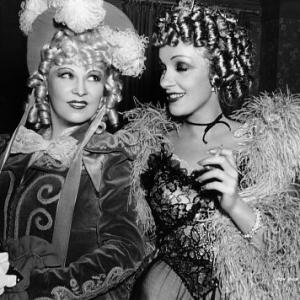 Mae West Marlene Dietrich in costume for DESTRY RIDES AGAIN Universal 1939 on set of MY LITTLE CHICKADEE Universal 1940 IV