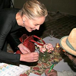 Sharon Stone gets her copy of the book A Feast at the Beach signed by author William Widmaier
