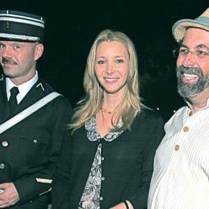 A French gendarme watches over Lisa Kudrow and author William Widmaier at the release party for his book A Feast at the Beach