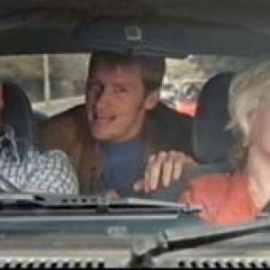 Barbie Wilde trapped in a car with Denis Leary for the UK Holstein Pils GET REAL TV commercial early 1990s