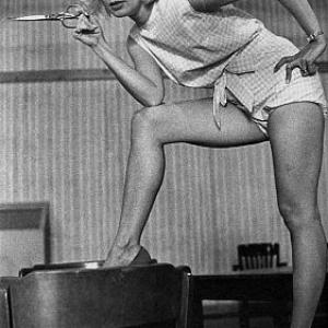 Joanne Woodward holding a pair of scissors on the set of 