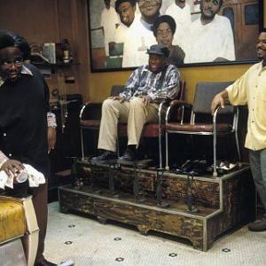 CEDRIC THE ENTERTAINER as Eddie, CARL WRIGHT as Checkers Fred, and ICE CUBE as Calvin hanging around the shop