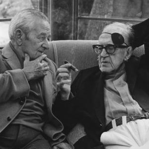 John Ford talking to William Wyler at a George Cukor hosted lunch for Luis Bunuel