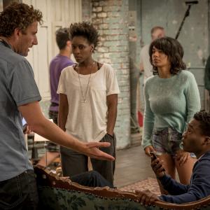 Still of director Euros Lynn with Sharon DuncanBrewster Red Madrell and Fisayo Akinade on the set of Cucumber2015
