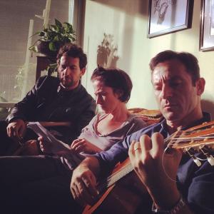 Dir SJ Clarkson going over the next scene with Ori Pfeffer and Jason Isaacs on the set of Dig