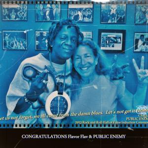 2013 Rock and Roll Hall of Fame Inductee PUBLIC ENEMY'S Flavor Flav and Daena Smoller enjoying a delicious piece of Flav's fried chicken.