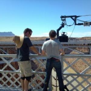 Actor Mark Kassen prepares to stand on the railing of the Navajo Bridge in Arizona Stunt Rigger was Rich Hopkins