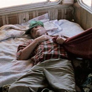 John (Maury Brooks) passed out in his Trailer.