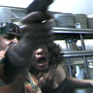 Gunman (Maxwell Sanchez) terrorizes Hostage (Unise Torez)