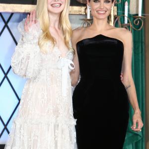 Actress Angelina Jolie L and Elle Fanning attend Maleficent Japan premiere at Ebisu Garden Place on June 23 2014 in Tokyo Japan