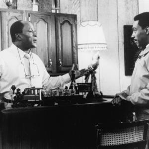 Still of Eddie Murphy and John Amos in Coming to America 1988