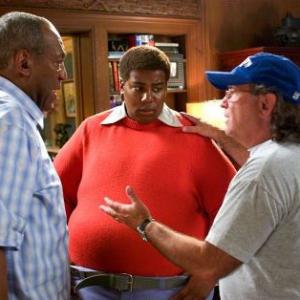 Bill Cosby and director Joel Zwick review a scene with Kenan Thompson on the set of FAT ALBERT