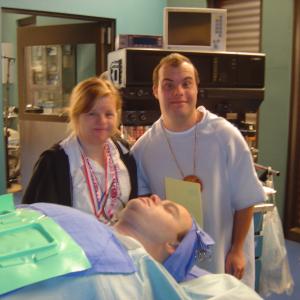 Blair Williamson and his girlfriend Susie standing over the FAKE BLAIR about to get filmed having surgery on NIPTUCK
